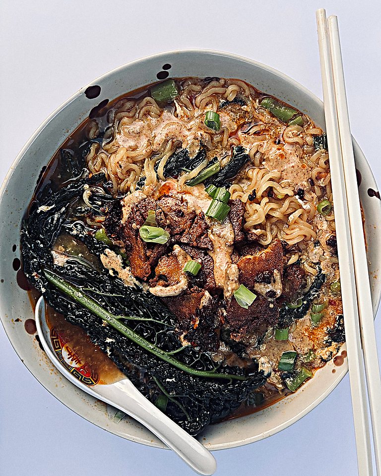 A bowl of ramen with cavolo nero, crispy mushrooms and Oh Mommy! sauce.
